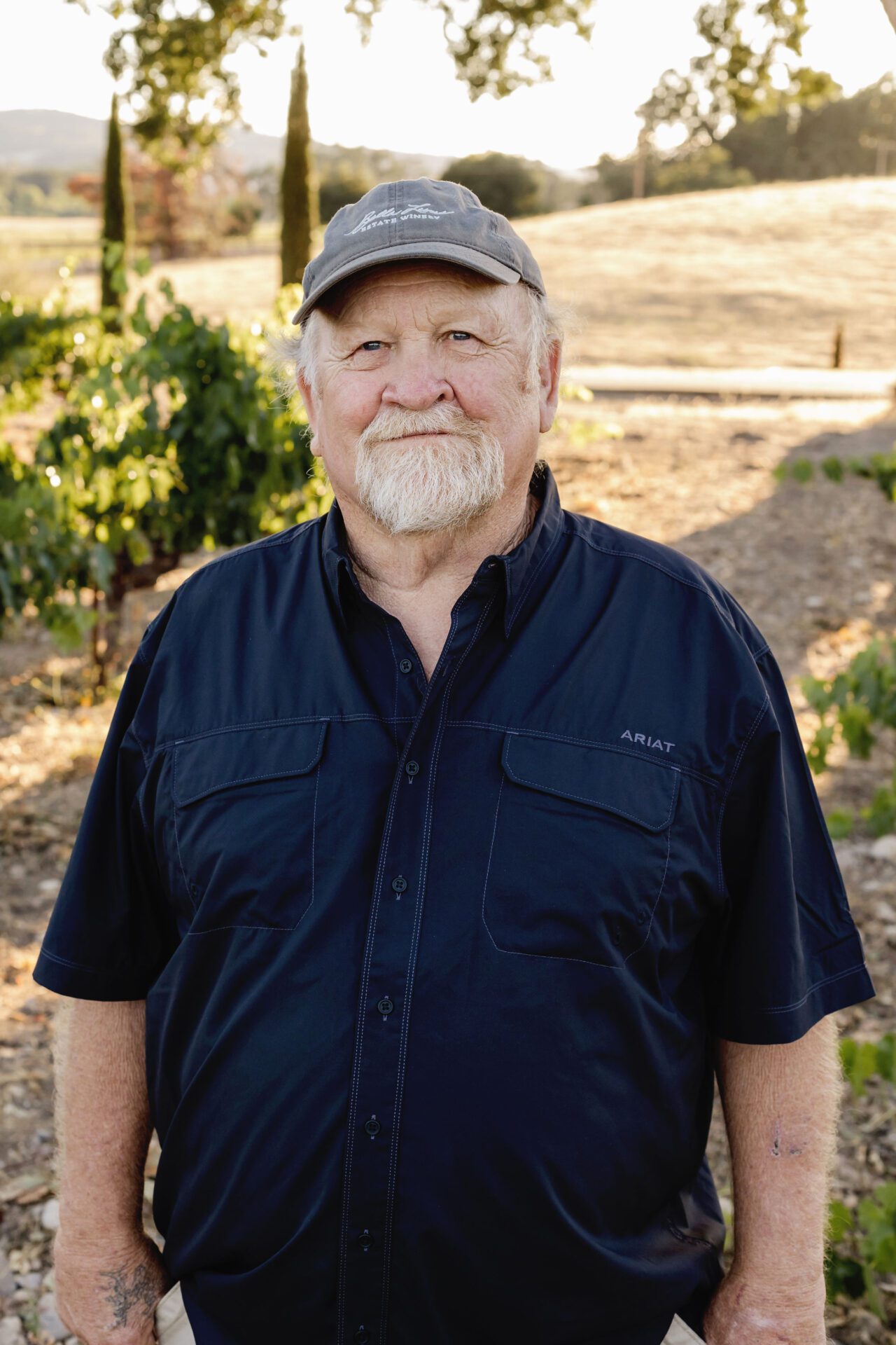 Kevin Healey, co-founder of Bella Luna Estate Winery, standing amidst the vineyard in Paso Robles, California.